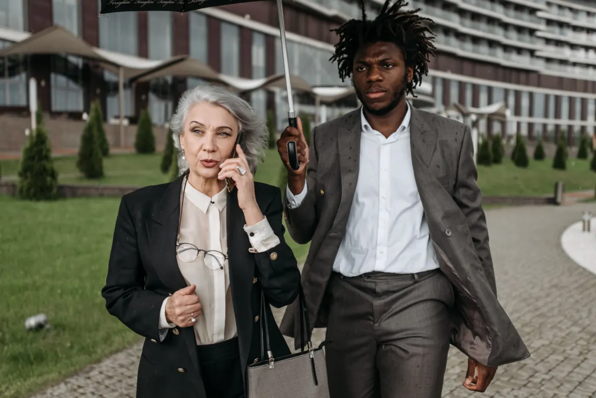 Two colleagues in tailoring walking outside an office building